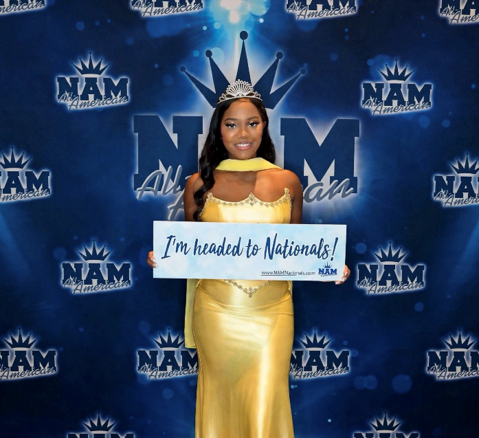 Alexis Mawere in yellow gown, elegant side pose